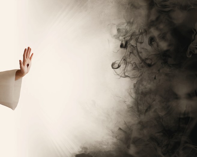 Hand of Jesus stopping darkness